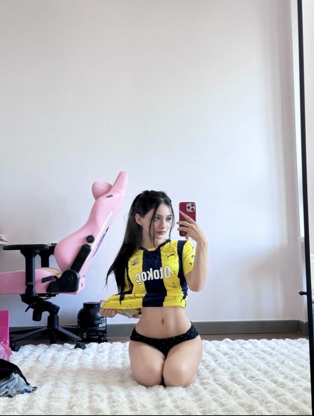 Cheering on her favorite team in her bedroom