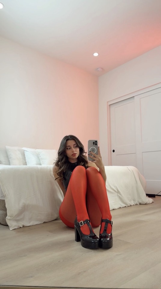 Beauty in red tights and black heels