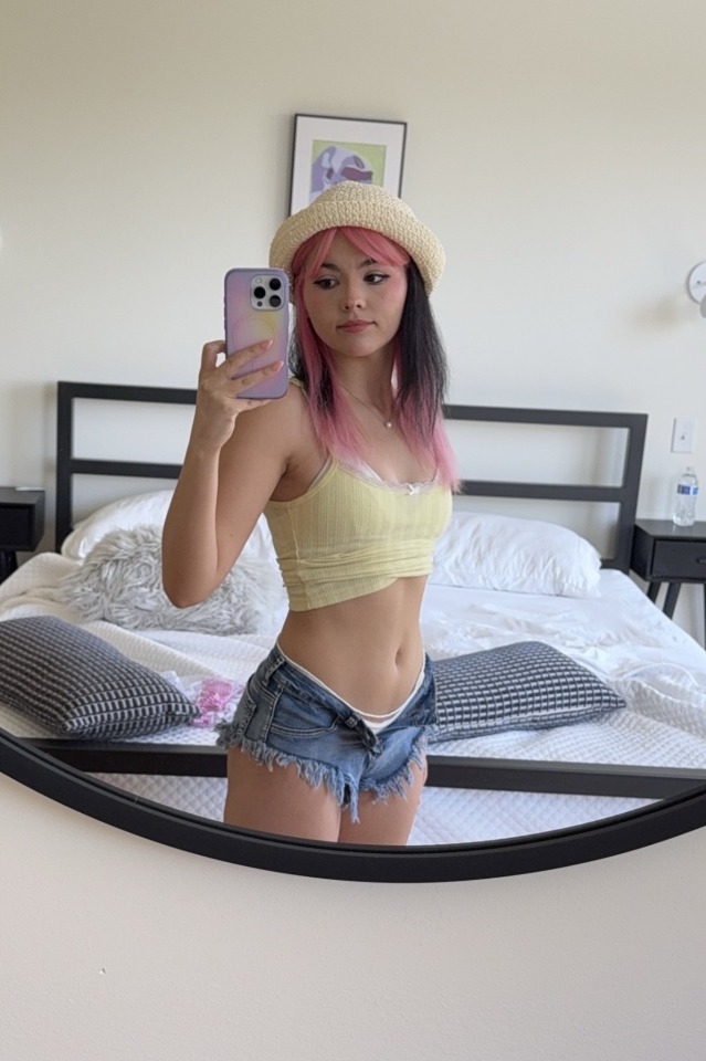 Pink hair and tiny denim shorts selfie
